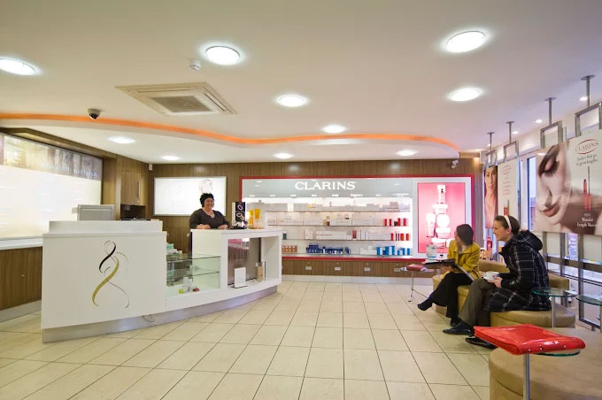 Modern beauty salon reception with skincare displays and a welcoming waiting area.